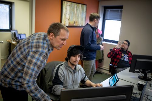 Two employees receive feedback from supervisors