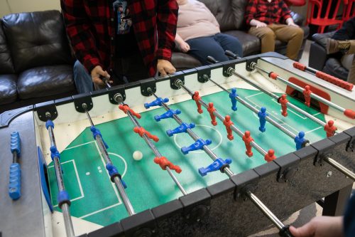 Employees from PQA play fooseball