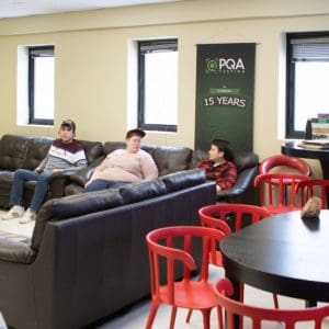 PQA employees gather together in break room