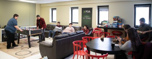 PQA employees gather together in break room