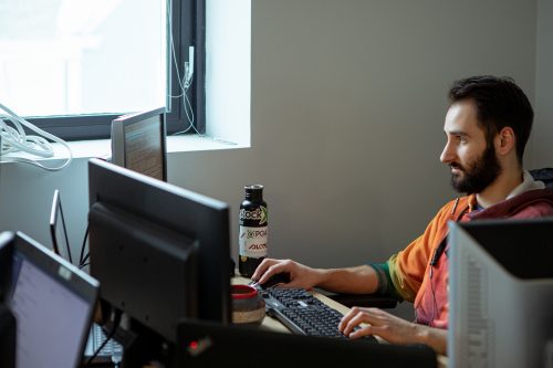 Male PQA Employee Working at His Computer